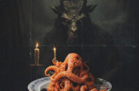 ACT-1 stands in a shadowy room with city lights behind him, as dark, cinematic artwork inspired by the ANTAGONIST cover hints at his “Greatful” single produced by King Vir2ue.