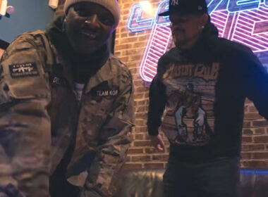 Dell-P stands confidently in an urban Philadelphia setting, delivering intense performance energy in “Superhero Flow,” symbolizing lyrical power, independence, and modern underground Hip-Hop visual storytelling.