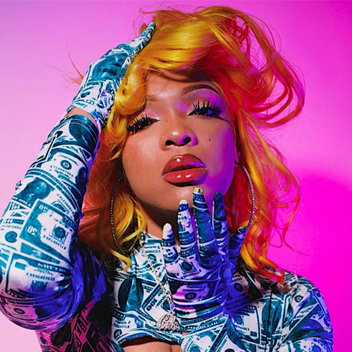 Ultra-realistic image of a vibrant female Hip-Hop artist reading fan comments on her phone in a colorful studio environment, symbolizing the modern comment economy where fan conversations influence which songs become hits — SpitFireHipHop Corporate Corner.