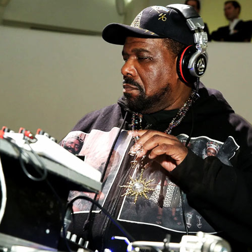 Ultra-realistic portrait of Afrika Bambaataa wearing sunglasses and a leather jacket, with bold headline “Hip-Hop Pioneer Dead” and SpitFireHipHop branding, representing breaking news of his death and legacy in hip-hop culture