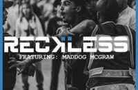 Black-and-white Hip-Hop street scene with police confrontation, bold “RECKLESS” title text — representing the intensity and chaos of Beat Clinic and Maddog McGraw’s single.