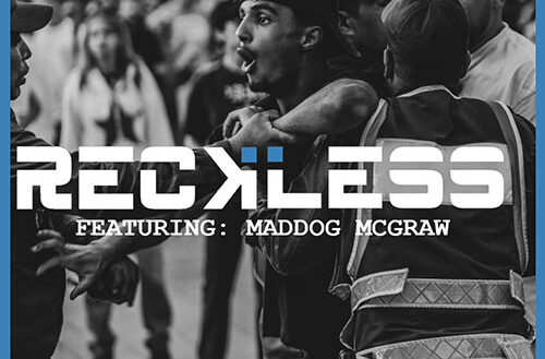 Black-and-white Hip-Hop street scene with police confrontation, bold “RECKLESS” title text — representing the intensity and chaos of Beat Clinic and Maddog McGraw’s single.