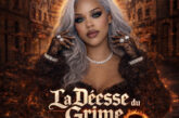 Female Hip-Hop artist with silver hair and bold makeup stands against a burning city backdrop with glowing halo light, representing the cinematic tone of La Déesse du Crime EP.