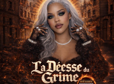 Female Hip-Hop artist with silver hair and bold makeup stands against a burning city backdrop with glowing halo light, representing the cinematic tone of La Déesse du Crime EP.