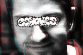 Close-up portrait of a man with glitch-style distortion and graffiti text across his eyes, representing the theme of “Law Abiding Citizen” with a dark urban aesthetic.