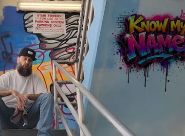 Travisty The Lazy Emcee sits beside colorful graffiti artwork in the “Know My Name” music video alongside visuals promoting the underground Hip-Hop single produced by DJ Kawon.