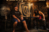 Jezus Martinez pose inside a dimly lit room with glowing gold typography promoting their EP THE SALAMANDER and the single “Hall of Mirrors.”