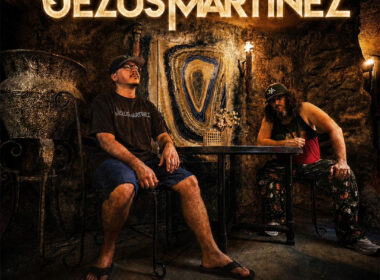 Jezus Martinez pose inside a dimly lit room with glowing gold typography promoting their EP THE SALAMANDER and the single “Hall of Mirrors.”