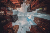 Cover artwork for Apollo Brown's instrumental single "Stranger Things," featuring an upward-looking view between towering city buildings with a cloudy sky centered above, creating an atmospheric and cinematic perspective.
