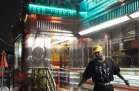 Fabolous outside a brightly lit diner at night in the “Lufthansa Heist Freestyle” music video.