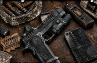 Cover art for Benny Slumz and HardMoney’s “Pistol Packing Punk,” showing a pistol, worn phone, radio, and cigars on a distressed brown tabletop with white lettering.