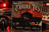 Distressed “Trauma Ties” cover with a large red eye, a church-like silhouette, a red car, and credits for Hanzo Bladez, Albany Lou, and SauceYin.